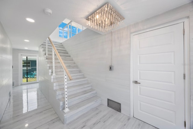 18077 3rd St E, Redington Shores, FL 33708 - staircase with a chandelier, recessed lighting, and plenty of natural light