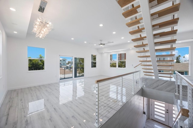 18077 3rd St E, Redington Shores, FL 33708 - unfurnished living room with recessed lighting, a chandelier, wood finished floors, and ceiling fan