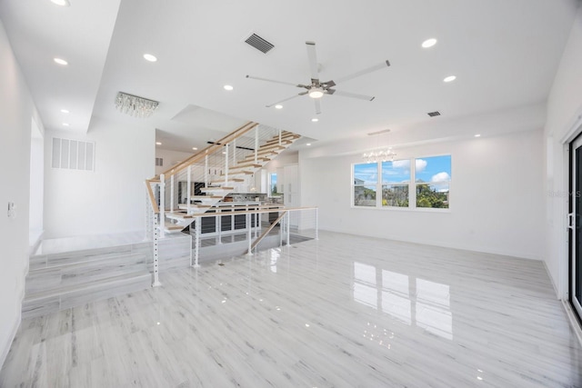 18077 3rd St E, Redington Shores, FL 33708 - unfurnished living room with stairway, ceiling fan, recessed lighting, and a chandelier