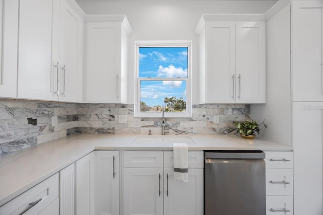 18077 3rd St E, Redington Shores, FL 33708 - kitchen featuring dishwasher, white cabinetry, and decorative backsplash