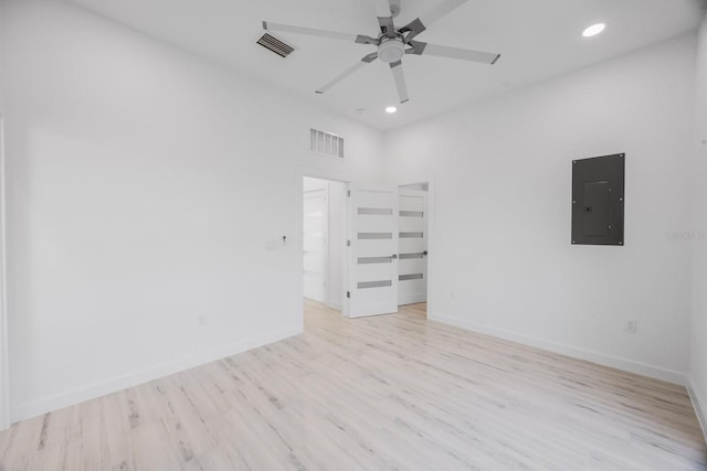 18077 3rd St E, Redington Shores, FL 33708 - unfurnished room with electric panel, recessed lighting, a ceiling fan, and light wood-style flooring