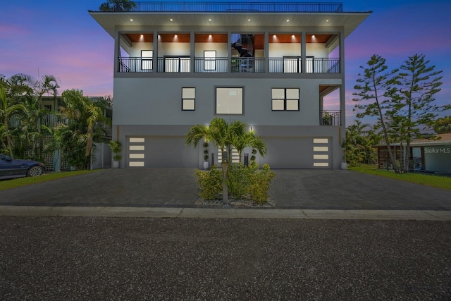 18077 3rd St E, Redington Shores, FL 33708 - view of front of home with an attached garage, driveway, and stucco siding