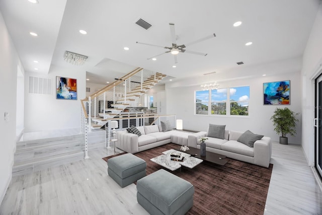 18077 3rd St E, Redington Shores, FL 33708 - living area with stairway, a ceiling fan, recessed lighting, a chandelier, and light wood-type flooring