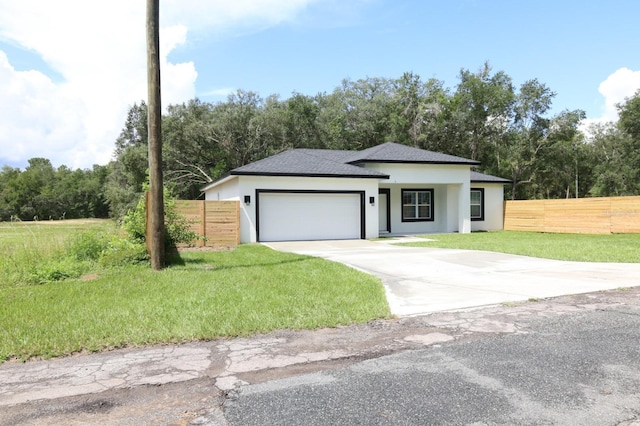 2522 W Castle Rd, Dunnellon, FL 34434 - view of front of house with stucco siding, a garage, driveway, and a shingled roof