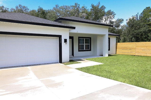 2522 W Castle Rd, Dunnellon, FL 34434 - view of front of property featuring stucco siding, concrete driveway, a garage, and a shingled roof