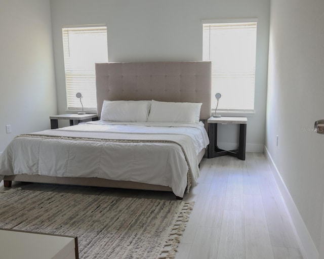 2522 W Castle Rd, Dunnellon, FL 34434 - bedroom with baseboards and wood finished floors