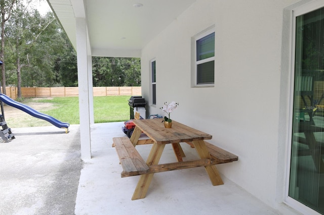 2522 W Castle Rd, Dunnellon, FL 34434 - fenced backyard with a patio, a playground, and grilling area