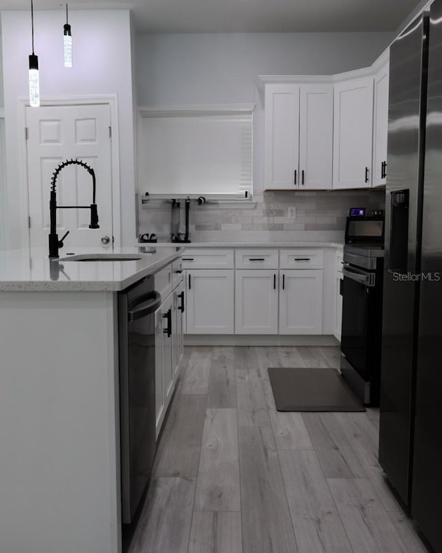 2522 W Castle Rd, Dunnellon, FL 34434 - kitchen with stainless steel refrigerator with ice dispenser, dishwasher, black electric range, white cabinets, and tasteful backsplash