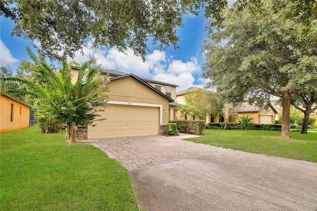 1037 Cypress Pointe Blvd, Davenport, FL 33896 - view of front of home featuring decorative driveway, stucco siding, a front yard, and a garage