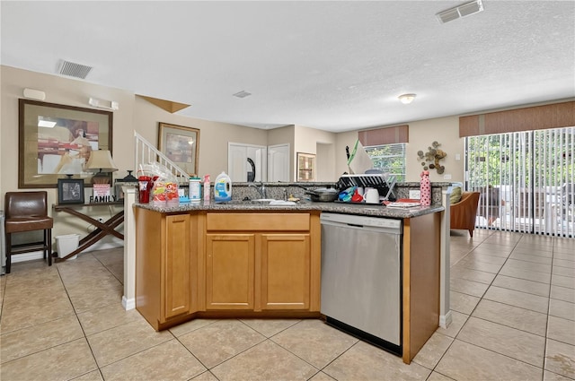 1037 Cypress Pointe Blvd, Davenport, FL 33896 - kitchen with dishwasher, light tile patterned floors, an island with sink, stone countertops, and a textured ceiling