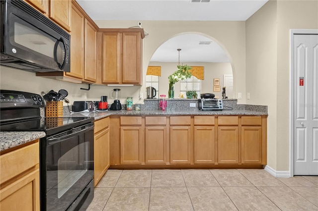 1037 Cypress Pointe Blvd, Davenport, FL 33896 - kitchen featuring black appliances, arched walkways, light tile patterned floors, and stone countertops