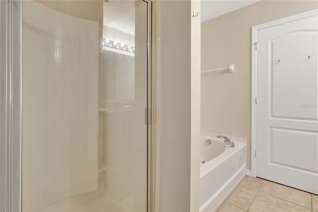 1037 Cypress Pointe Blvd, Davenport, FL 33896 - bathroom featuring tile patterned flooring, a stall shower, and a garden tub