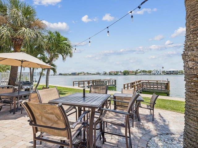 10265 Gulf Blvd Unit A107, Saint Petersburg, FL 33706 - view of patio / terrace with outdoor dining area and a water view