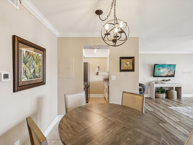 10265 Gulf Blvd Unit A107, Saint Petersburg, FL 33706 - dining room featuring a chandelier, ornamental molding, electric panel, and light tile patterned flooring