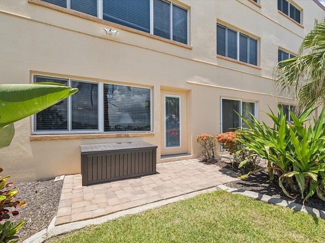 10265 Gulf Blvd Unit A107, Saint Petersburg, FL 33706 - back of property featuring stucco siding and a patio area