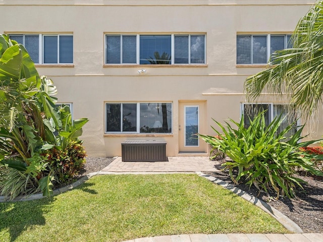 10265 Gulf Blvd Unit A107, Saint Petersburg, FL 33706 - rear view of house featuring a yard and stucco siding