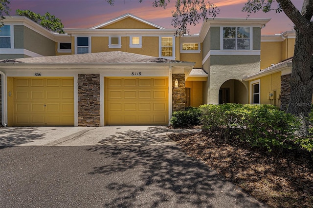 8118 Stone Path Way, Tampa, FL 33647 - view of front facade with stucco siding, stone siding, and driveway