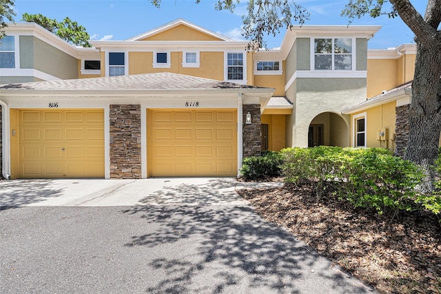 8118 Stone Path Way, Tampa, FL 33647 - traditional home featuring stucco siding, stone siding, driveway, and a garage