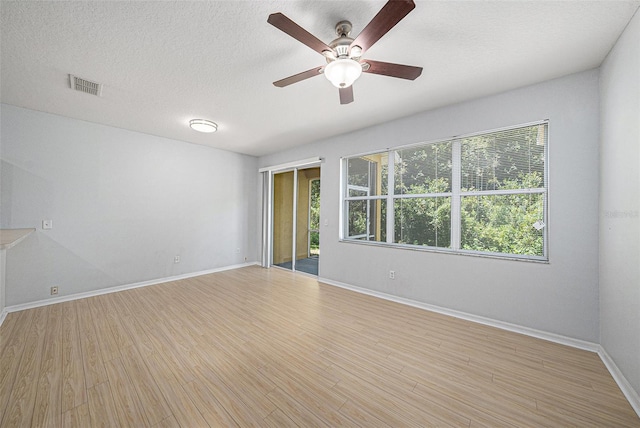 8118 Stone Path Way, Tampa, FL 33647 - empty room featuring light wood-style floors, ceiling fan, and a textured ceiling