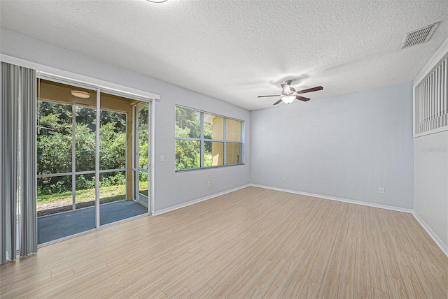8118 Stone Path Way, Tampa, FL 33647 - spare room with ceiling fan, light wood finished floors, and a textured ceiling