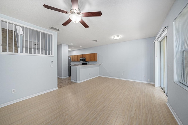 8118 Stone Path Way, Tampa, FL 33647 - unfurnished living room featuring light wood-style floors and ceiling fan