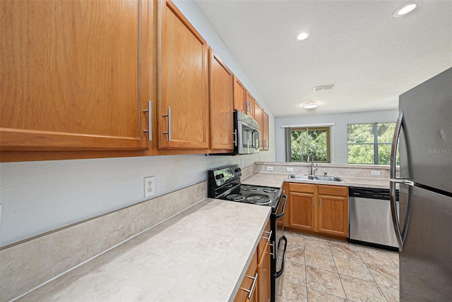 8118 Stone Path Way, Tampa, FL 33647 - kitchen featuring stainless steel appliances, light countertops, brown cabinetry, recessed lighting, and a textured ceiling