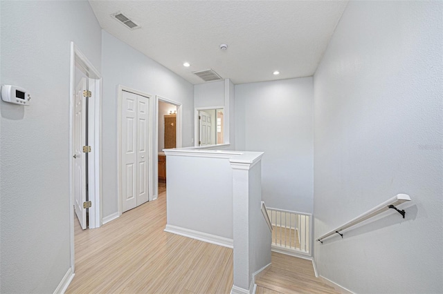 8118 Stone Path Way, Tampa, FL 33647 - corridor with an upstairs landing, light wood-type flooring, and recessed lighting