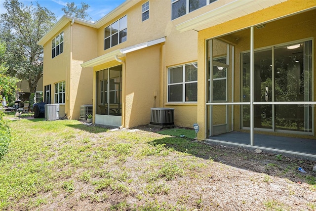 8118 Stone Path Way, Tampa, FL 33647 - rear view of house featuring stucco siding, a yard, and a sunroom