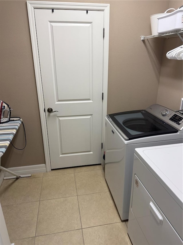 4432 Vermillion Sky Dr, Wesley Chapel, FL 33544 - washroom featuring independent washer and dryer and light tile patterned floors