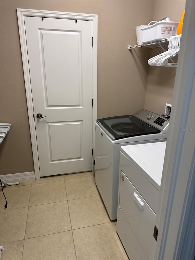 4432 Vermillion Sky Dr, Wesley Chapel, FL 33544 - laundry room with washing machine and dryer and light tile patterned floors