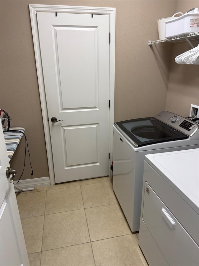 4432 Vermillion Sky Dr, Wesley Chapel, FL 33544 - laundry room with washing machine and dryer and light tile patterned flooring