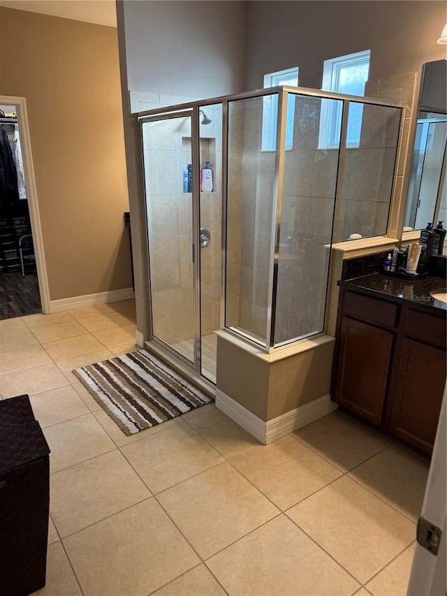 4432 Vermillion Sky Dr, Wesley Chapel, FL 33544 - bathroom with vanity, a stall shower, tile patterned floors, and a walk in closet
