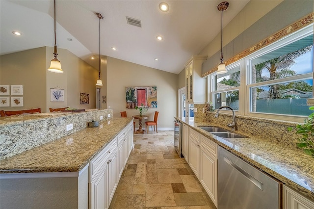 13425 San Rafael Dr, Largo, FL 33774 - kitchen featuring stone tile flooring, stainless steel dishwasher, lofted ceiling, light stone countertops, and recessed lighting