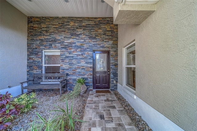 13425 San Rafael Dr, Largo, FL 33774 - doorway to property featuring stucco siding and stone siding