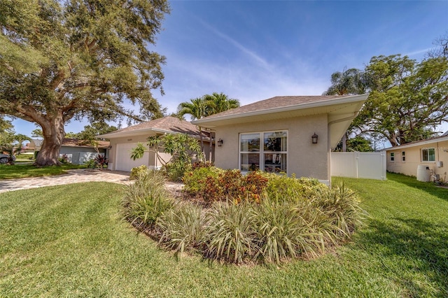 13425 San Rafael Dr, Largo, FL 33774 - view of front of house with a garage, stucco siding, and driveway
