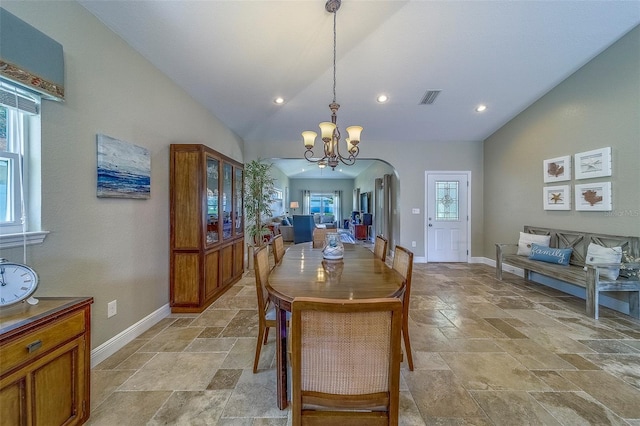 13425 San Rafael Dr, Largo, FL 33774 - dining area with stone tile flooring, arched walkways, a chandelier, lofted ceiling, and recessed lighting