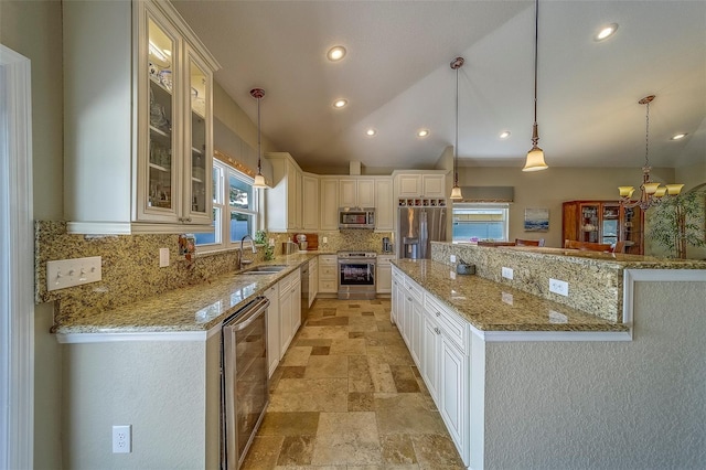 13425 San Rafael Dr, Largo, FL 33774 - kitchen with stainless steel appliances, tasteful backsplash, stone tile floors, glass insert cabinets, and hanging light fixtures