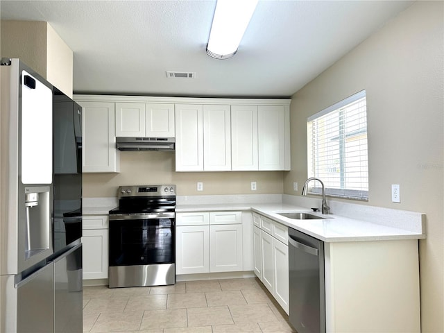 1235 Alpine Lake Dr, Brandon, FL 33511 - kitchen with stainless steel appliances, under cabinet range hood, light countertops, and white cabinetry