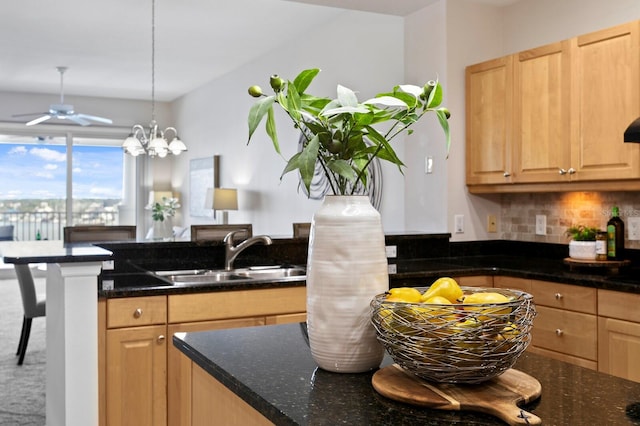 17735 Gulf Blvd Unit 502, Redington Shores, FL 33708 - kitchen featuring light brown cabinetry, tasteful backsplash, dark stone counters, and a ceiling fan