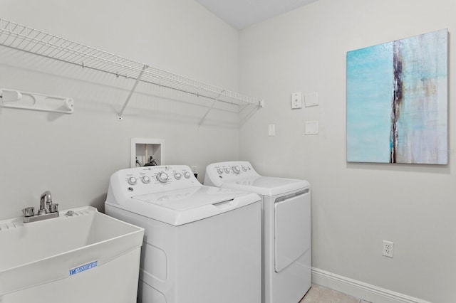 17735 Gulf Blvd Unit 502, Redington Shores, FL 33708 - washroom featuring separate washer and dryer and baseboards