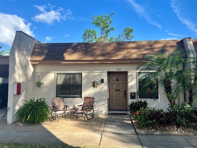 1359 Mission Cir Unit 48A, Clearwater, FL 33759 - property entrance with roof with shingles and stucco siding