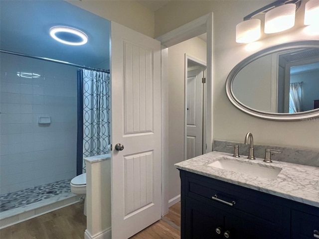 1359 Mission Cir Unit 48A, Clearwater, FL 33759 - bathroom with wood finished floors, vanity, and a tile shower