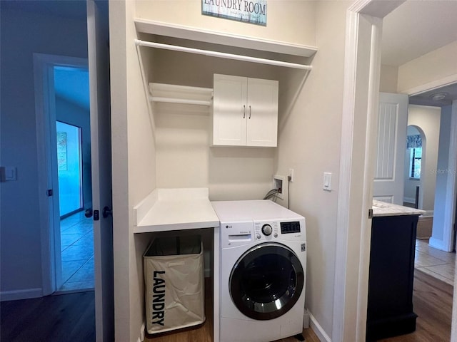 1359 Mission Cir Unit 48A, Clearwater, FL 33759 - laundry area with cabinet space, wood finished floors, and washing machine and dryer