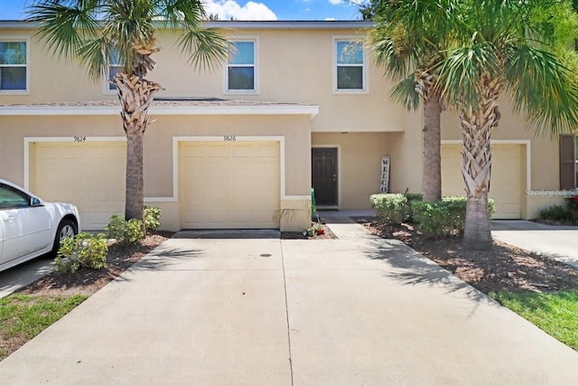 9826 Hound Chase Dr, Gibsonton, FL 33534 - mediterranean / spanish-style home with an attached garage, stucco siding, and concrete driveway