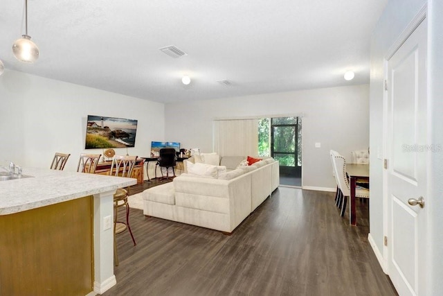 9826 Hound Chase Dr, Gibsonton, FL 33534 - living area with dark wood-style floors and baseboards