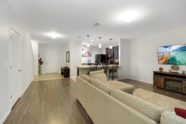 9826 Hound Chase Dr, Gibsonton, FL 33534 - living room with wood finished floors and baseboards