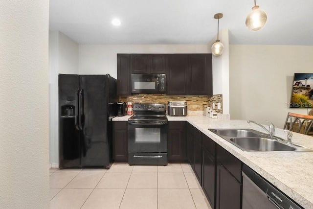 9826 Hound Chase Dr, Gibsonton, FL 33534 - kitchen with black appliances, backsplash, light countertops, hanging light fixtures, and light tile patterned floors