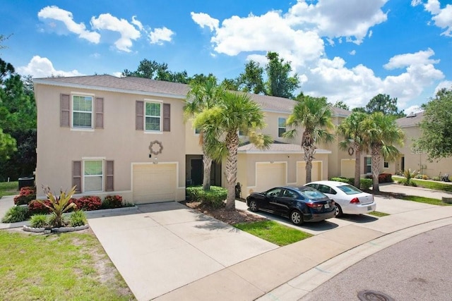9826 Hound Chase Dr, Gibsonton, FL 33534 - view of front of home featuring a garage, driveway, and stucco siding