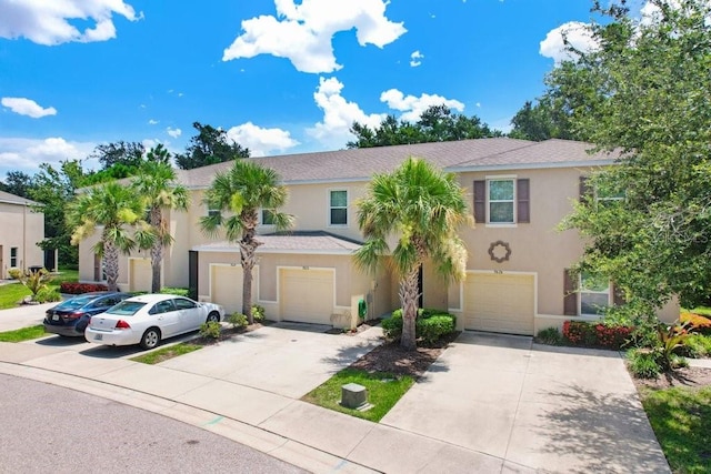 9826 Hound Chase Dr, Gibsonton, FL 33534 - view of front of property with an attached garage, driveway, and stucco siding