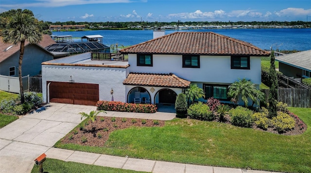 10866 Harborside Dr, Largo, FL 33773 - mediterranean / spanish-style house with a chimney, stucco siding, a garage, a tile roof, and covered porch